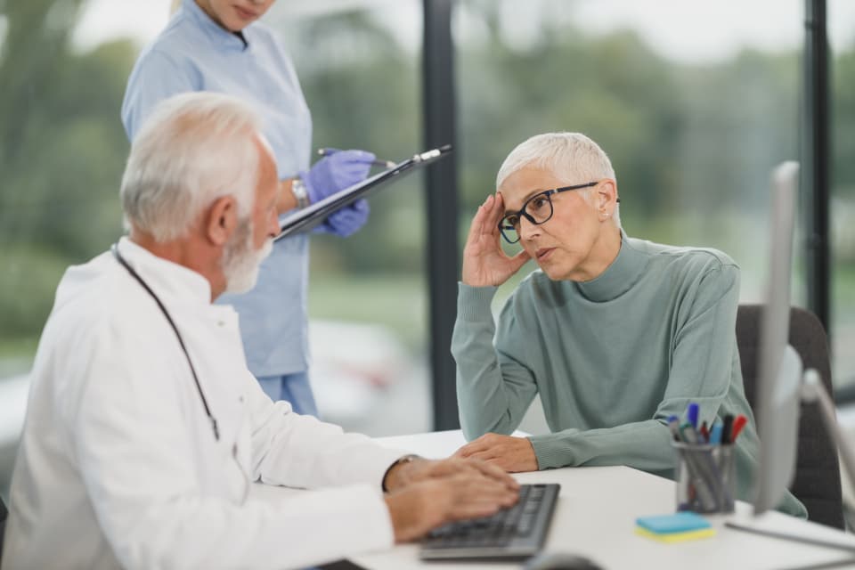 A dentist talking a patient through their results