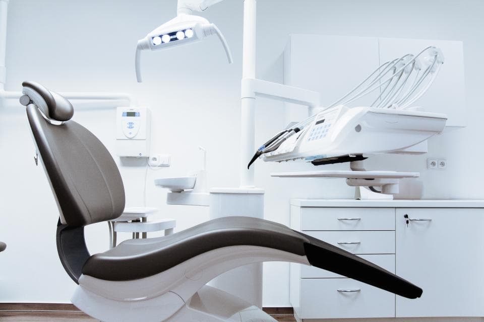A bright treatment room with a modern dental chair